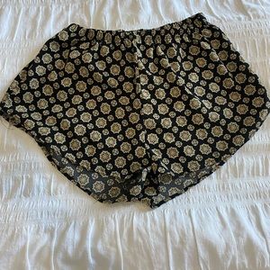 Beige and black flowy shorts.